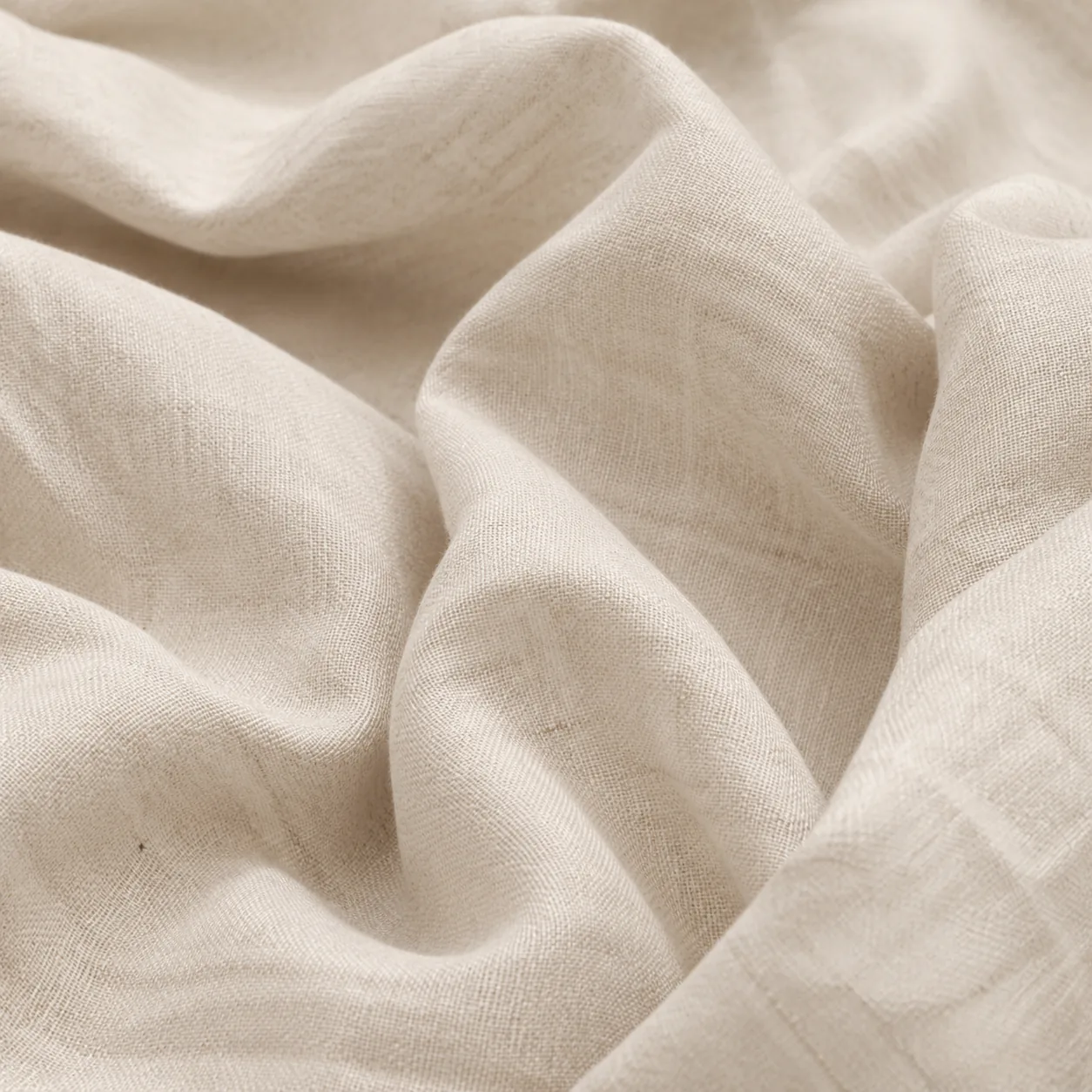 Textured linen fabric backdrop with dried flowers in natural light